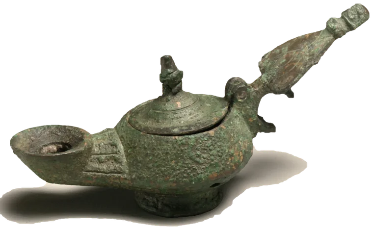 A green bronze oil lamp with a lid and a long handle.