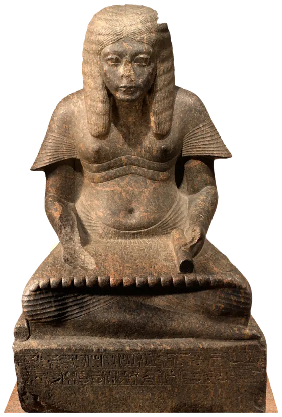 A seated scribe in granite with a papyrus unrolled across his lap.