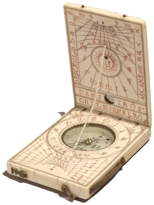 An ivory pocket sundial opened like a book, with a compass set into its base and a thread stretched between its two leaves.